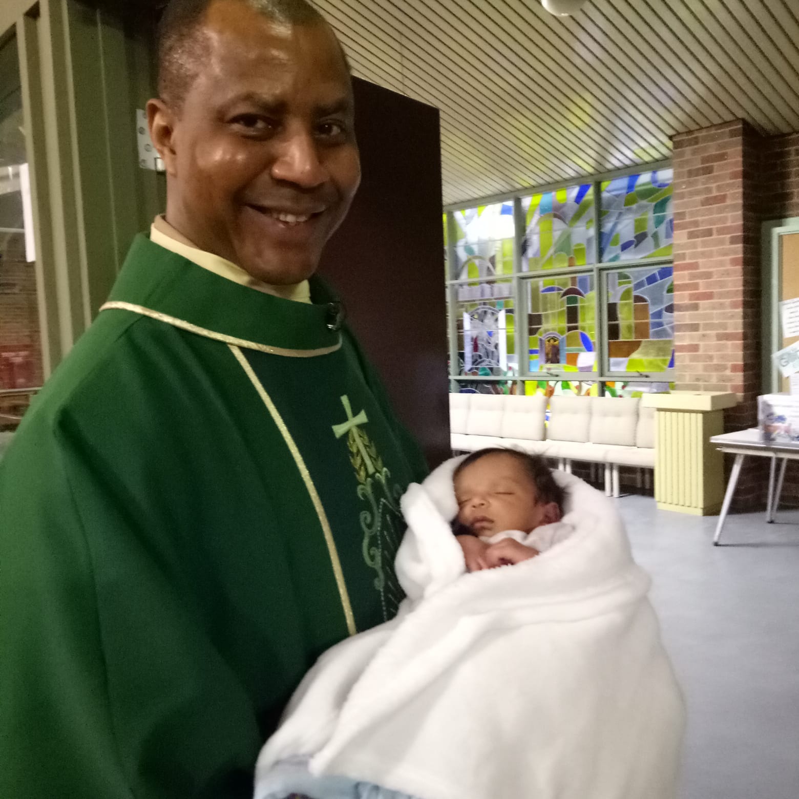 Fr Chinua with a baby